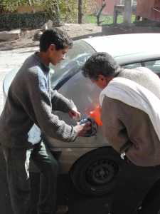 Ahmed pours petrol into our tank
