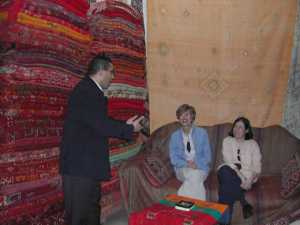 Omar explains his Berber Carpets to Becky and Robin
